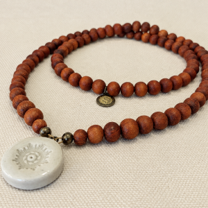 Long necklace of brown wooden bayong beads and Living Design Pendant